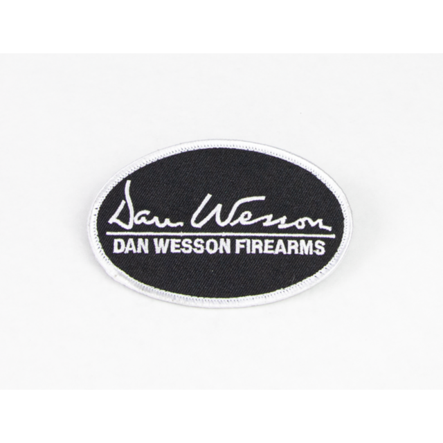 A black oval patch outlined with a white border features the text "Dan Wesson" in cursive, while "DAN WESSON FIREARMS" is prominently displayed below, encapsulating the spirit of this iconic brand in the DAN WESSON PATCH.